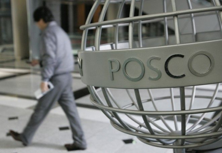 An employee of steelmaker POSCO walks at the company's headquarters in Seoul