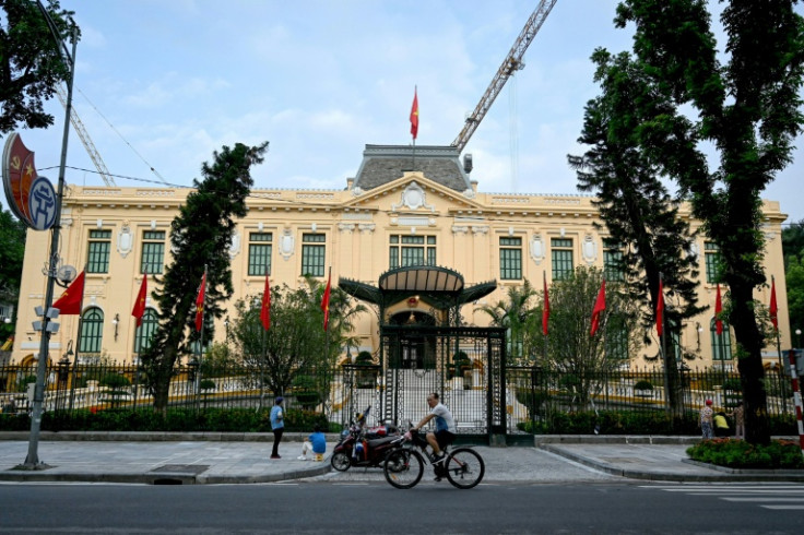 A man cycles past the Government Guest House in Hanoi. Crispy banh mi baguettes, grand colonial facades and babbling Francophone schoolchildren are lingering reminders of the French presence that once dominated Vietnam
