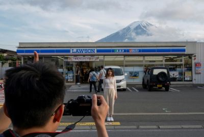Last year authorities erected a barrier in front of a convenience store to stop tourists from blocking roads while taking pictures of Mount Fuji in the background