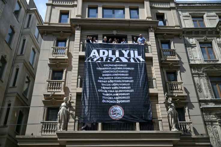 Lawyers in crossfire: Istanbul Bar Association members unfurl a protest banner at their HQ