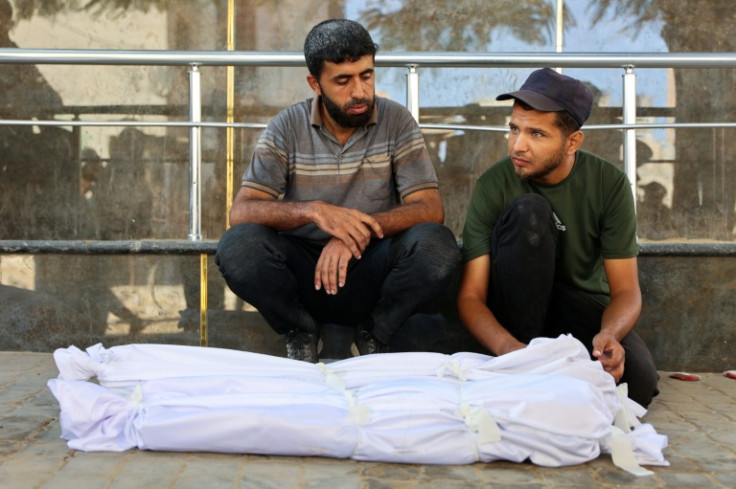 Palestinians mourn by the bodies of relatives killed in Israeli strikes at al-Shifa hospital in Gaza City