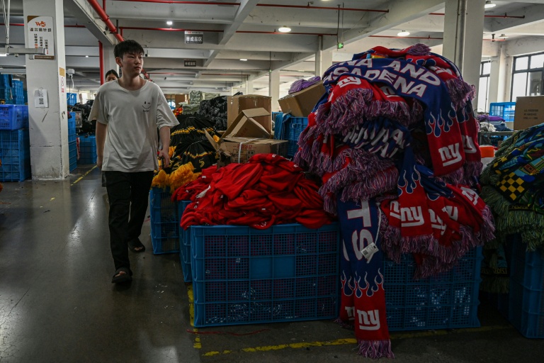 https://d.ibtimes.com/en/full/4622565/employee-walks-past-pile-knitwear-products-factory-that-produces-hats-scarves-yiwu-eastern.jpg