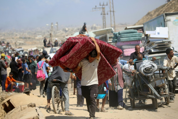 Palestinians from Gaza City move southwards with their belongings, on the coastal road near the Nuseirat refugee camp in the central Gaza Strip, on September 19, 2025. The Israeli military warned on September 19, that it will operate with "unprecedented f