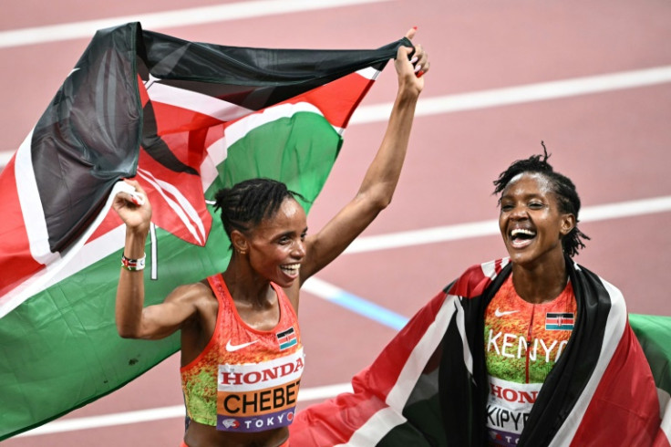 Friends and rivals: World championships 5,000 metres winner Beatrice Chebet enjoys her victory with fellow Kenyan and silver medallist Faith Kipyegon