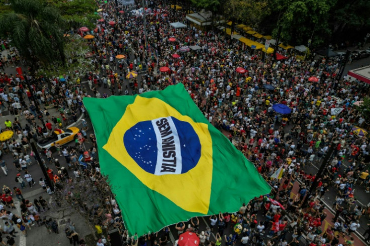 People carry a huge Brazilian flag reading "No amnesty" during the protest in Sao Paulo