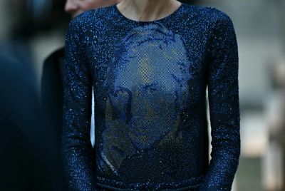 The final dress in the show, a sweeping blue glittering gown, featured the Armani's face, drawing applause