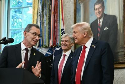 Pfizer CEO Albert Bourla (L) speaks in the White House as Medicare and Medicaid Administrator Mehmet Oz and US President Donald Trump look on during an announcement on reducing prescription drug prices