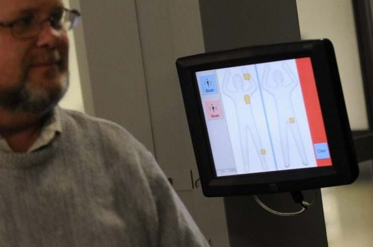 A Transportation Security Administration departs a body scanner during a demonstration of new software in Arlington