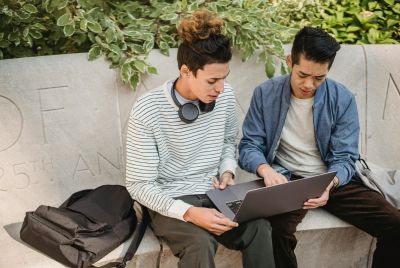 A graduate student reviews financial aid documents as federal loan