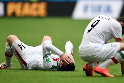 Iranian soccer players react after losing to Bosnia-Hercegovina.