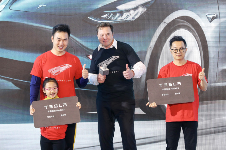 Tesla CEO Elon Musk (C) poses for photos with buyers