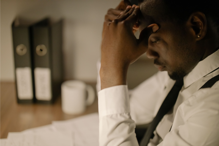 Side view of a stressed businessman in white shirt