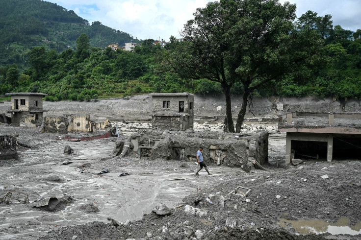 Man Walks Through Flood Sludge in Nuwakot