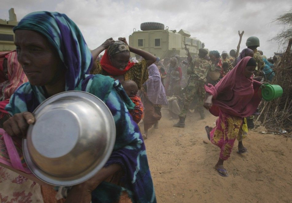 Women rush into a feeding centre in a camp established by the Somali Transitional Federal Government for the internally displaced people in Mogadishu
