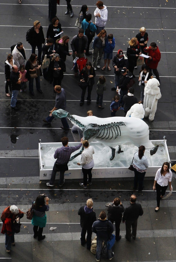 People watch a melting ice polar bear at Circular Quay in central Sydney