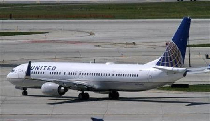 A United Airlines plane with the Continental Airlines logo on its tail, taxis to the runway at O'Hare International airport in Chicago