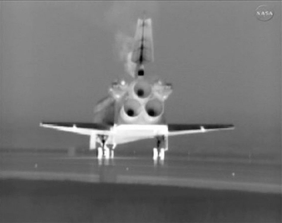 The space shuttle Atlantis makes a night landing at the Kennedy Space Center in Florida in this image from NASA TV