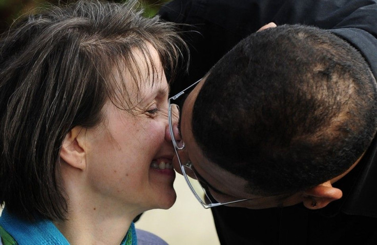 British multiple sclerosis sufferer Debbie Purdy and her husband Omar Puente kiss outside of the House of Lords in central London