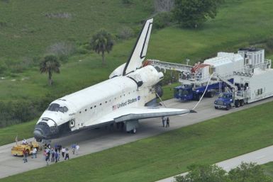 Space shuttle Atlantis is towed to its hangar after landing at the Kennedy Space Center in Cape Canaveral, Florida