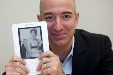 Jeff Bezos, CEO of Amazon.com Inc., shows a Kindle in Cupertino, California 