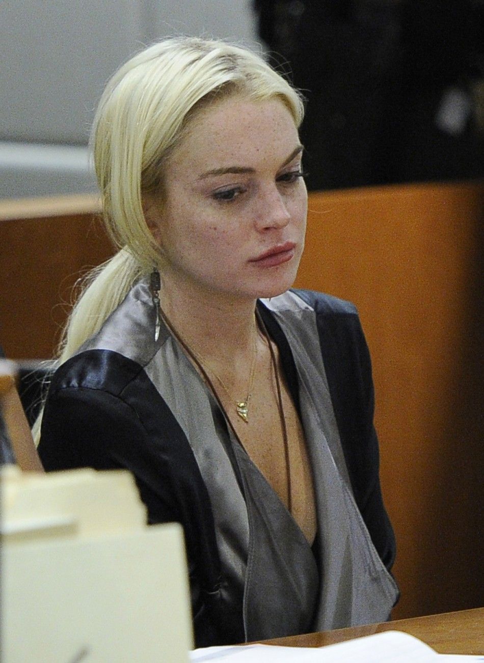 Actress Lindsay Lohan sits in court during a compliance check to report her progress on 480 hours of community service she must do for shoplifting a necklace from a Venice jeweler, in Los Angeles