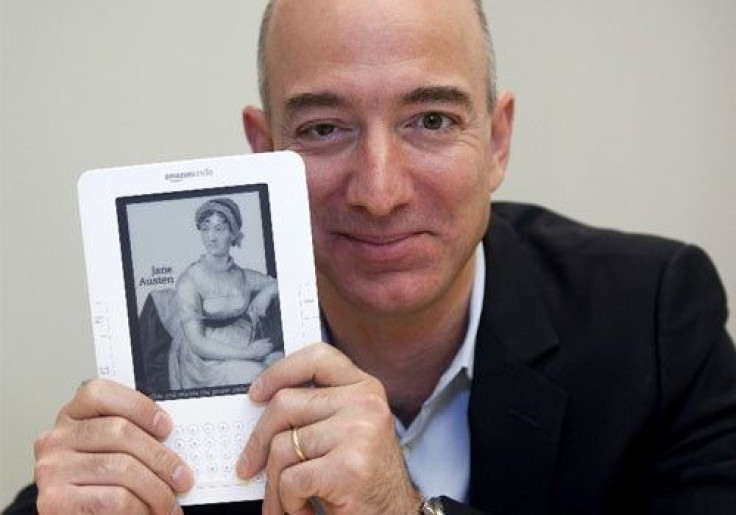 Jeff Bezos, CEO of Amazon.com Inc., shows a Kindle in Cupertino, California 