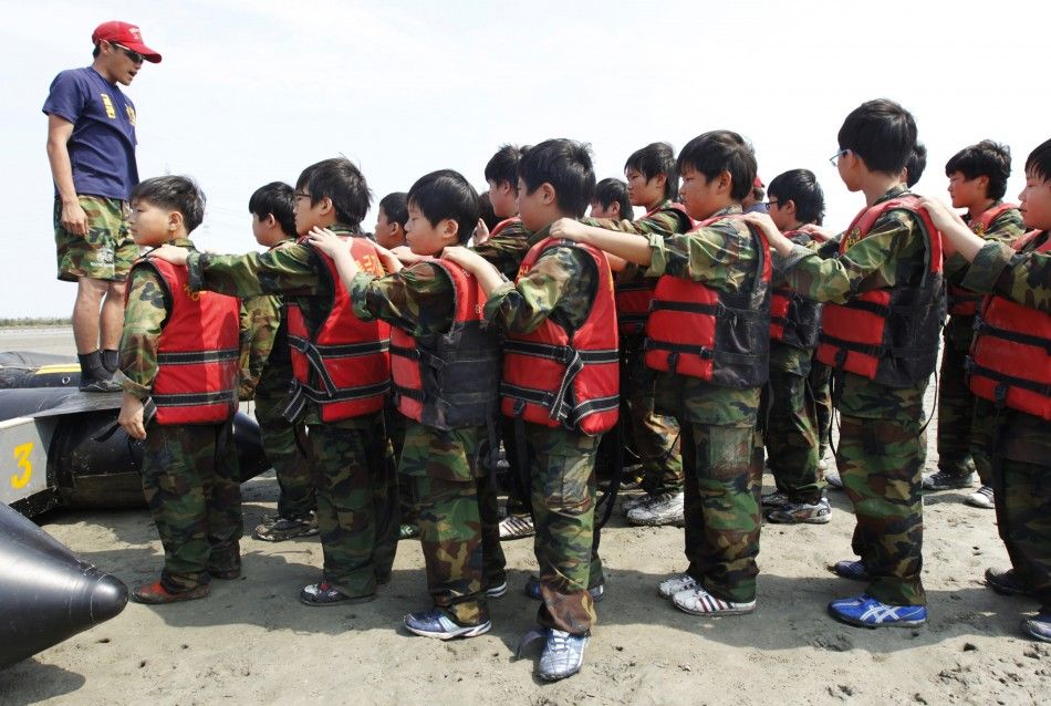 A camp instructor briefs elementary school students during a summer military camp for civilians at the Cheongryong Self-denial Training Camp in Ansan