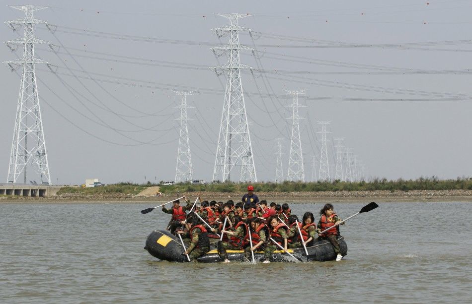 Elementary school students row rubber boats as they participate in a summer military camp at the Cheongryong Self-denial Training Camp in Ansan