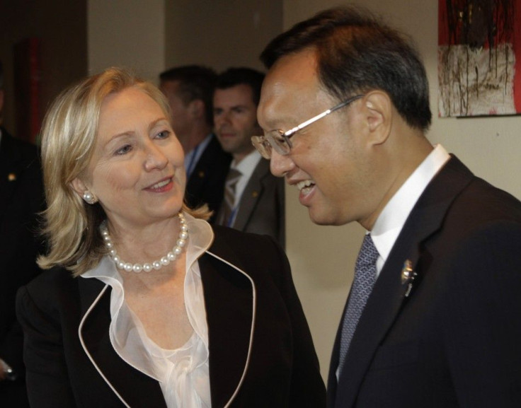 U.S. Secretary of State Hillary Clinton speaks with China's Foreign Minister Yang Jiechi before a bilateral meeting in Nusa Dua
