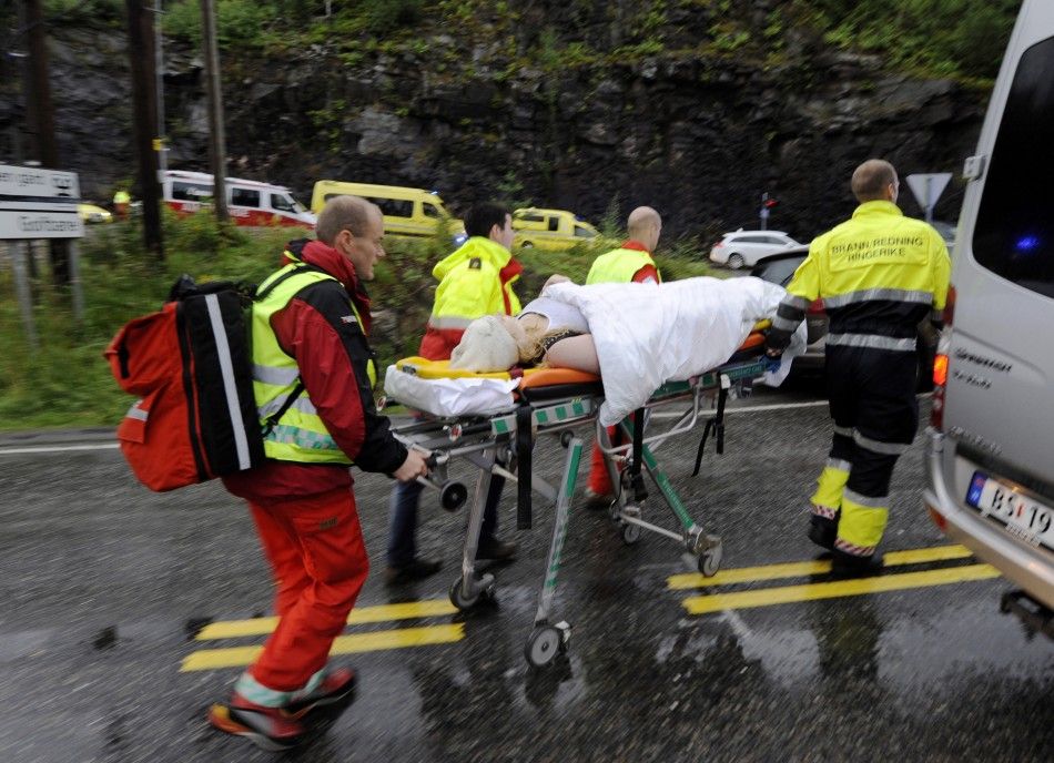 Rescue personnel push an injured youth on a stretcher in Storoya
