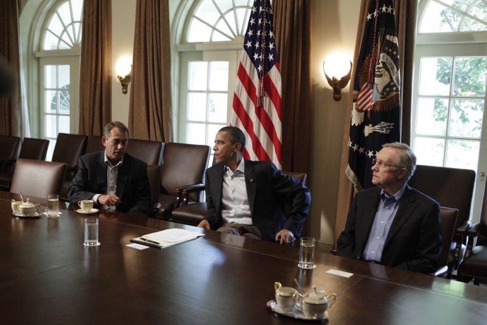 U.S. President Barack Obama C sit with House Speaker John Boehner R-OH L and Senate Majority Leader Harry Reid