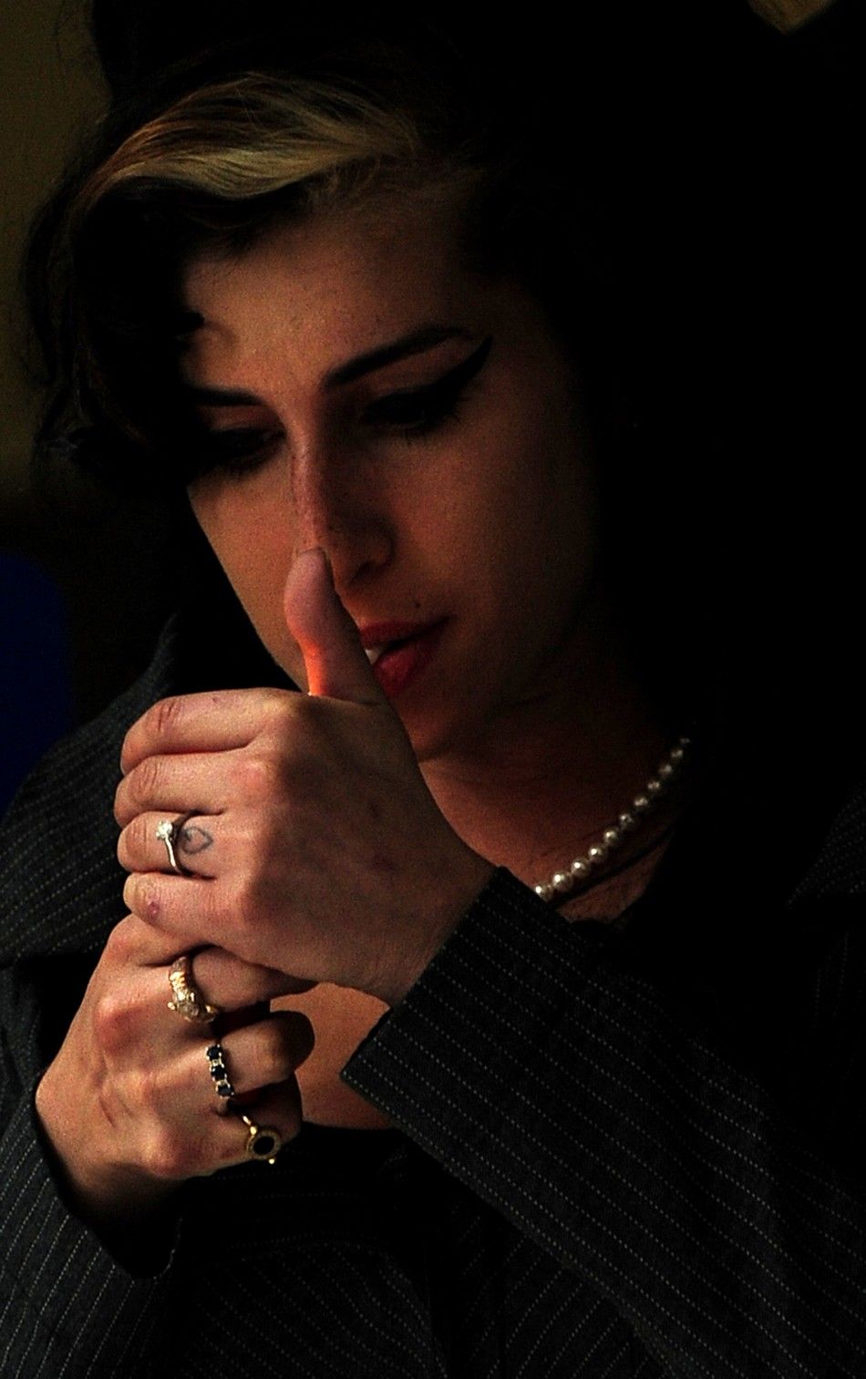 Winehouse smokes a cigarette outside Westminster Magistrates Court in central London