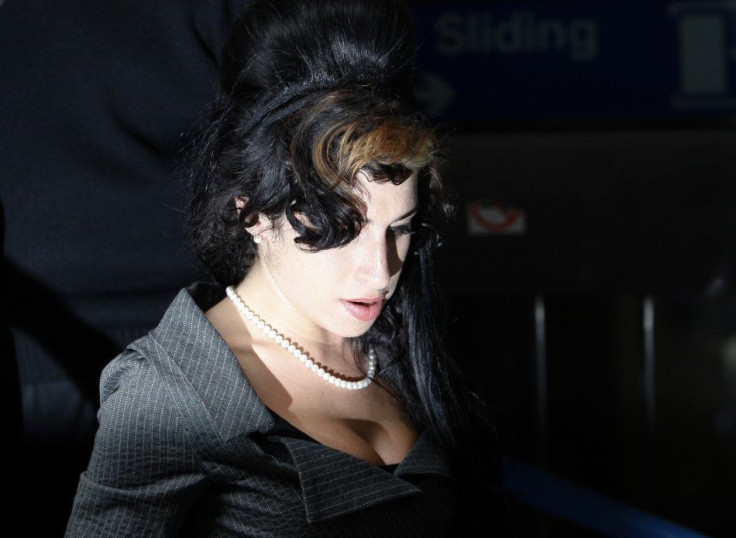 British singer Amy Winehouse leaves Westminster Magistrates Court in London July 23, 2009