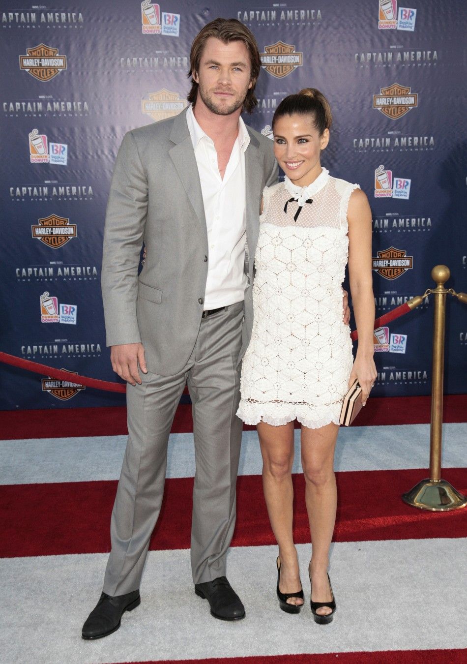 Actor Hemsworth and his wife pose as they arrive at the quotCaptain America The First Avengerquot film premiere in Hollywood