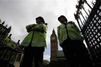 Police officers stand on duty outside the Houses of Parliament in Central London