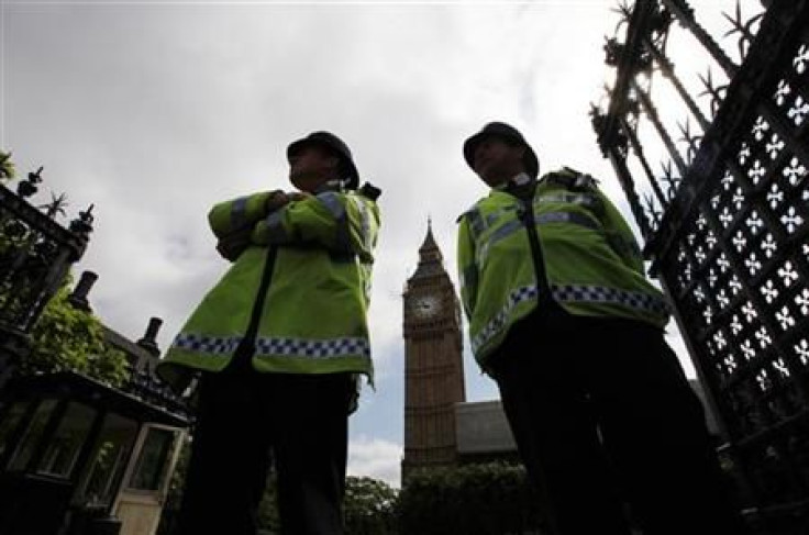 Police officers stand on duty outside the Houses of Parliament in Central London