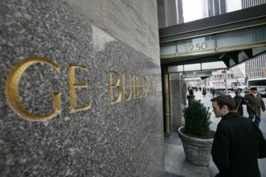 A man enters the General Electric building at 1250 Avenue of the Americas, also known as 30 Rockefeller Plaza in New York