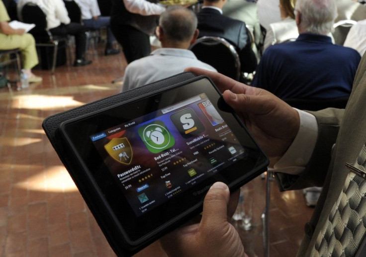 A man holds a BlackBerry PlayBook during the RIM annual general meeting of shareholders in Waterloo 12/07/2011
