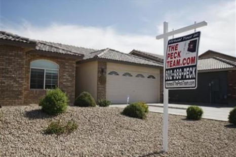 A real estate sales sign sits outside of a house for sale in Phoenix, Arizona