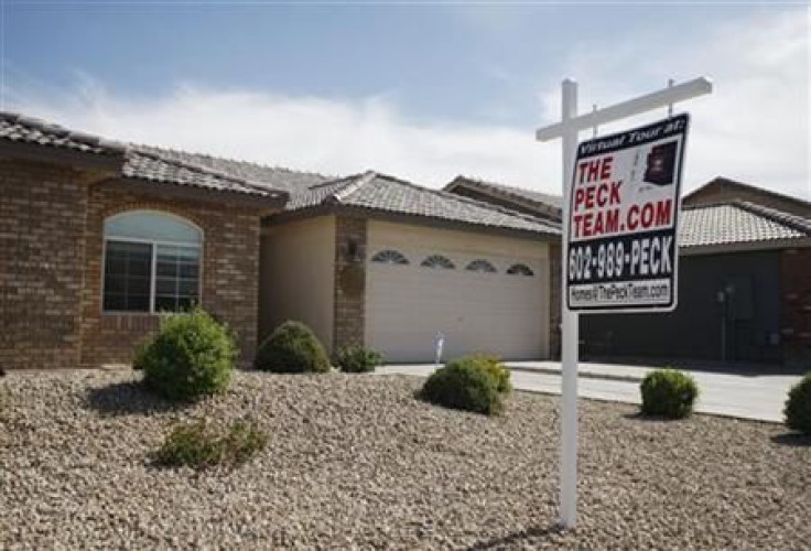 A real estate sales sign sits outside of a house for sale in Phoenix, Arizona