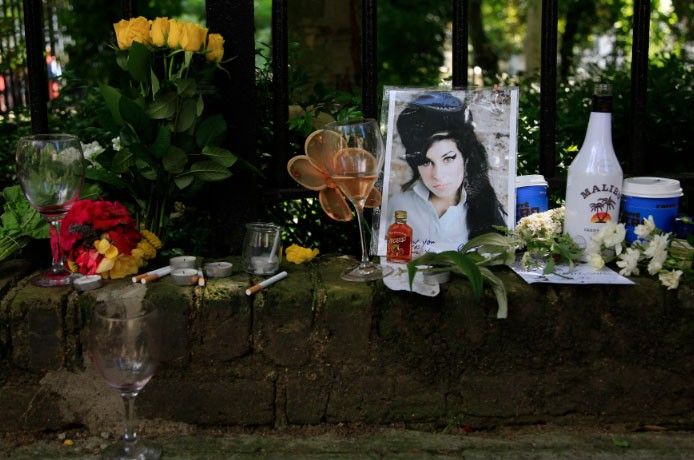 Flowers and tributes are seen outside the home of Amy Winehouse in London July 24, 2011