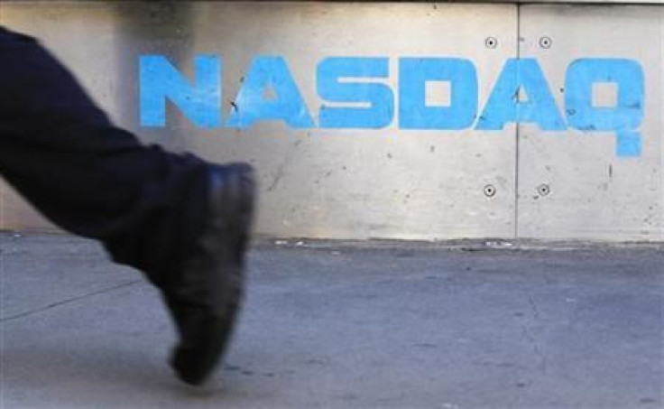 A pedestrian walks past the NASDAQ building in New York City