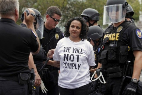 A demonstrator is arrested during a protest against Arizona's controversial Senate Bill 1070 immigration law outside the U.S. District Court in Phoenix July 22, 2010.