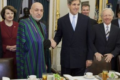 Afghan President Hamid Karzai (2nd L) shakes hands with Senator John Kerry (D-MA) during a luncheon hosted by the Senate Foreign Relations Committee
