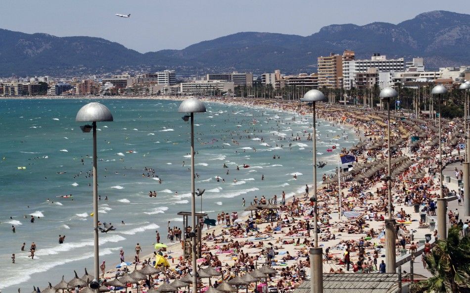 Tourists Crowd Palma de Mallorcas Arenal Beach, on the Spanish Balearic Island of Mallorca, on July 25, 2011.