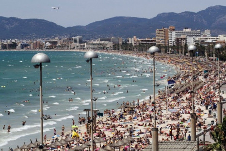 Tourists Crowd Palma de Mallorca's Arenal Beach, on the Spanish Balearic Island of Mallorca, on July 25, 2011.
