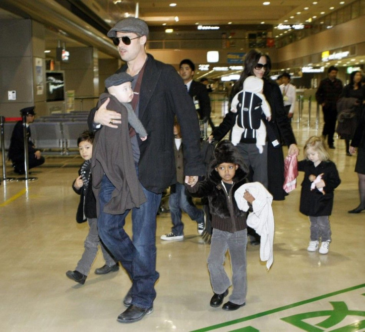 U.S. actors Pitt and Jolie arrive with their children at Narita airport.