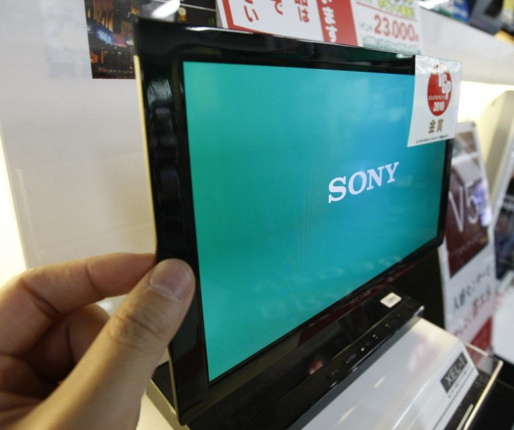 A man touches Sony&#039;s OLED TV during a photo opportunity at an electronic shop in Tokyo