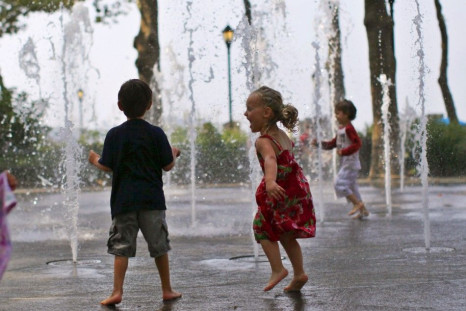 Children play in a fountain to cool off at New York City's Battery Park in lower Manhattan as heat wave spread over eastern U.S.