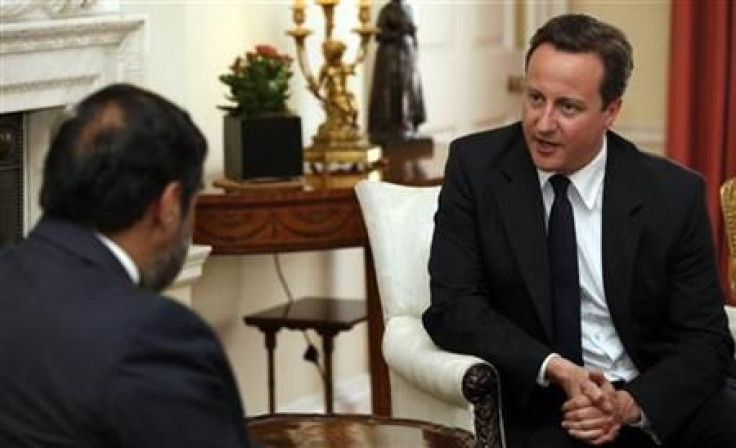 Britain&#039;s Prime Minister David Cameron speaks to India&#039;s Trade Minister Anand Sharma during their meeting at number 10 Downing Street in London